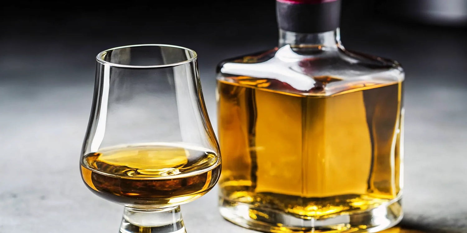 Bottle and glass of golden 123 Organic Tequila Diablito Extra Añejo.