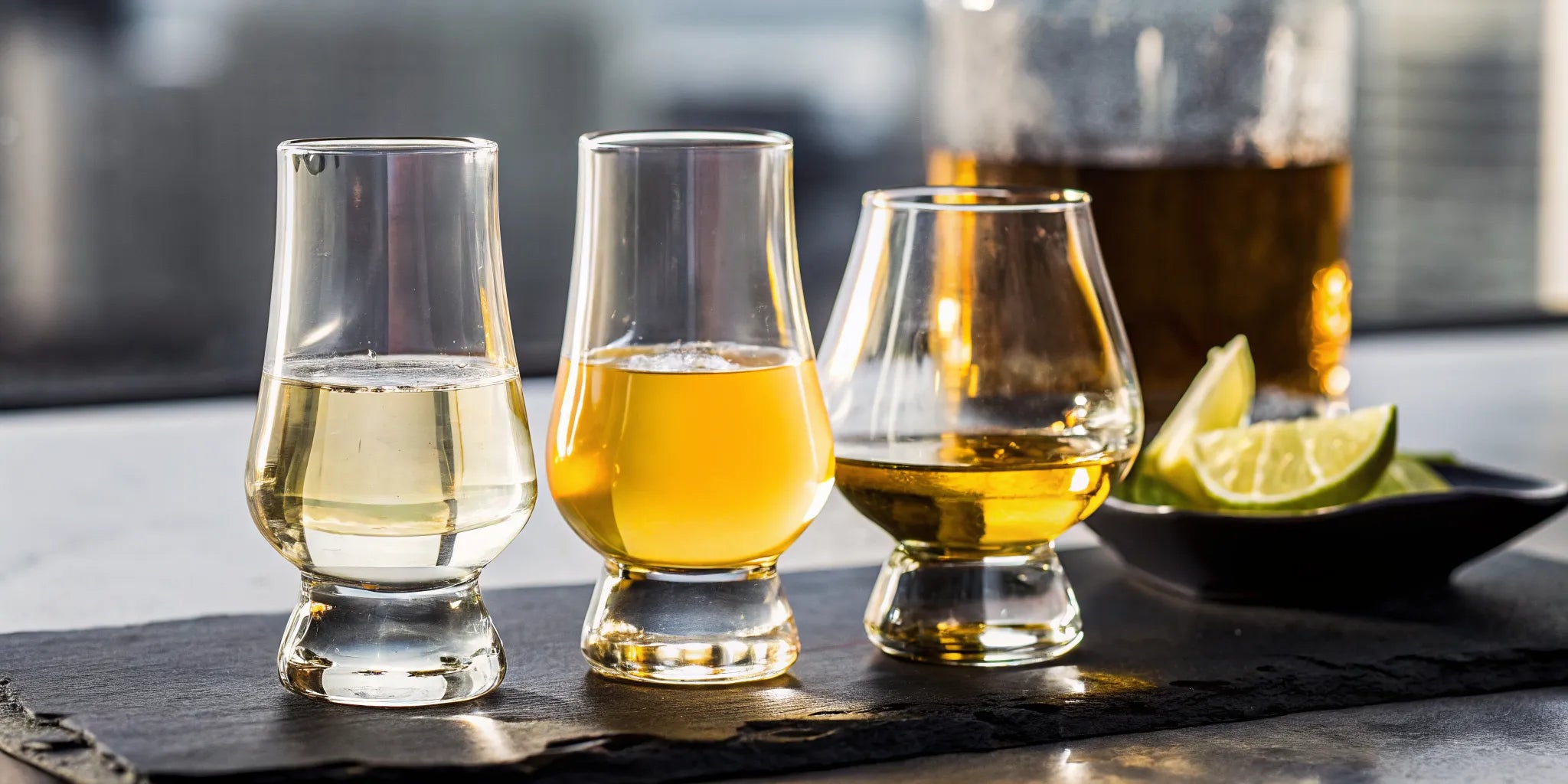 A tequila tasting flight with three different tequilas and lime wedges in Philadelphia.