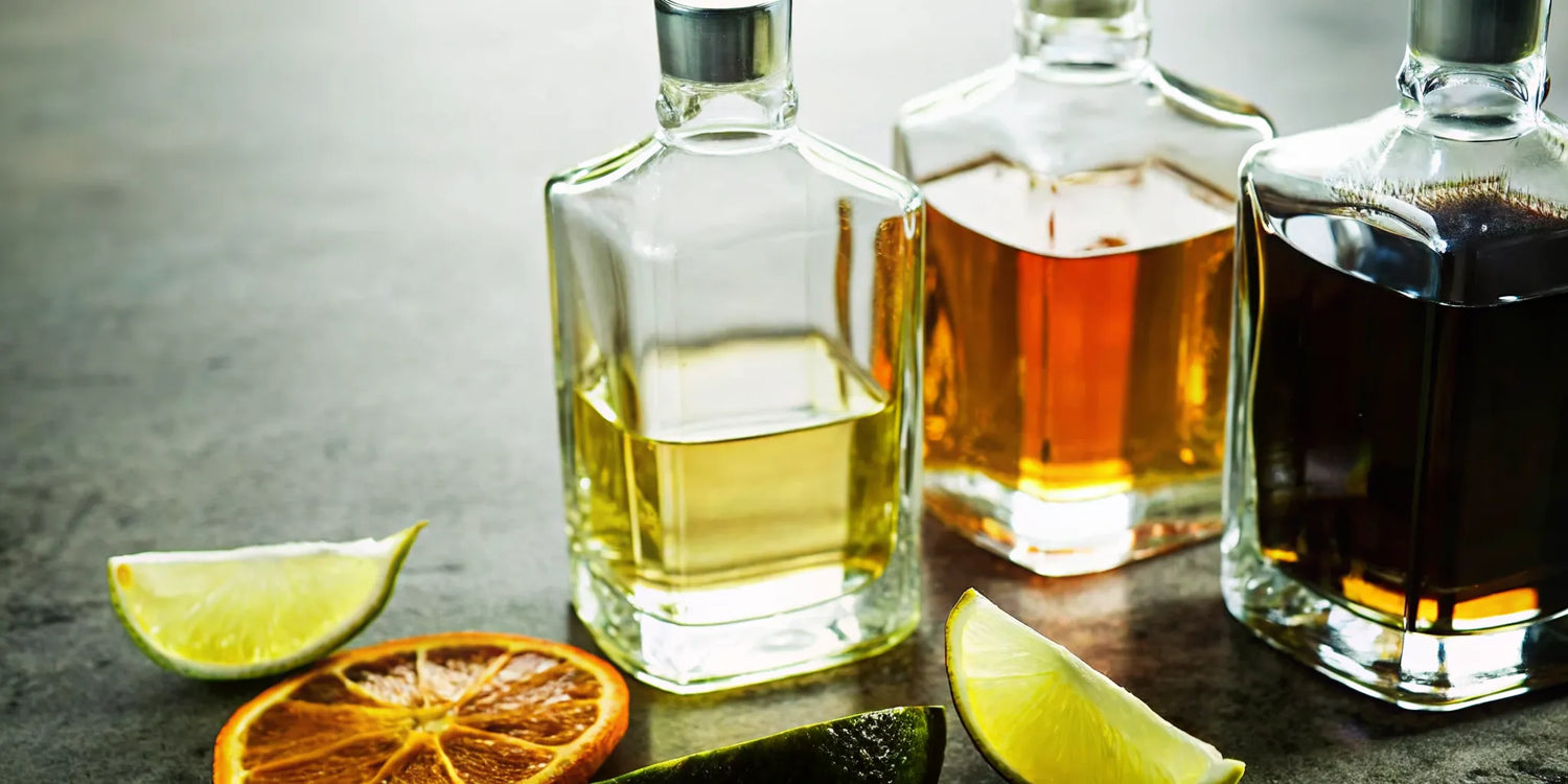 Three bottles showing different types of aged tequila, set up for a tasting.