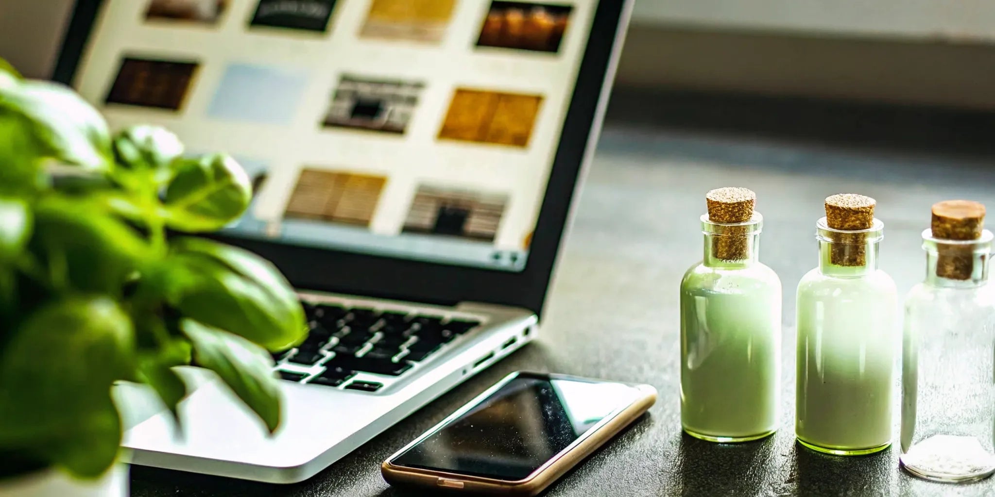 Shopping to buy small batch mezcal online with a laptop and several bottles.