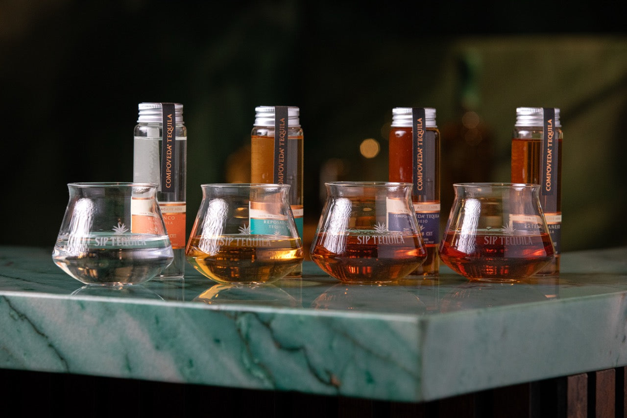 The four Compoveda dram kit pours lined up in tasting glasses